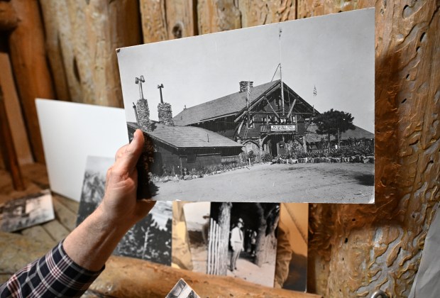 Bill Carle, proprietor of the Pahaska Tepee Gift Shop and Cafe, at 987 Lookout Mountain Road, shows a historic photo that is among the items Carle has at his gift shop and cafe in Golden, Colorado on Dec. 8, 2024. The historic Pahaska Tepee building was built in 1921 as a museum, gift shop, and café after Buffalo Bill's burial on Lookout Mountain. The museum moved to a new building next door in 1979. Carle's family has worked a variety of concessions with the city for 68 years. However, the City and County of Denver owns the building and has told Bill Carle that his lease is up and he needs to vacate the property by the end of January.  After decades of operating the gift shop and cafe, Carle will be out and the building will be closed until further notice. The city of Denver, which owns the building, wants him out even though they don't say much about their plans for the place. Thus one of Colorado's better-known tourist destinations will be shuttered next year. The store will permanently close on Dec. 31st, 2024. (Photo by Helen H. Richardson/The Denver Post)