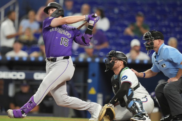 Colorado Rockies' Hunter Goodman (15) follows through on hitting a triple during the first inning of a baseball game against the Miami Marlins, Wednesday, June 4, 2025, in Miami. (AP Photo/Lynne Sladky)